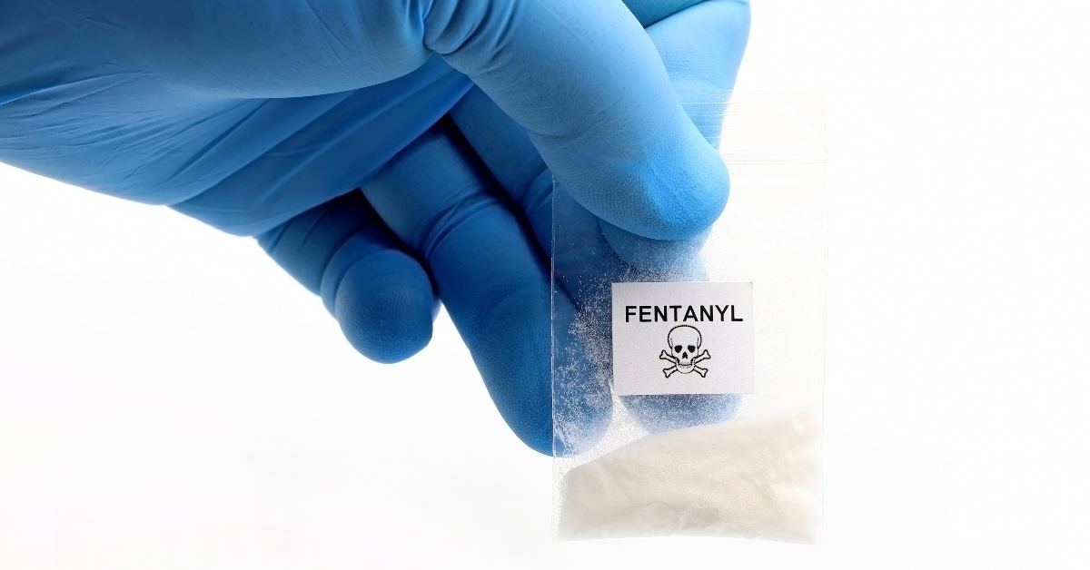 Hand holding a bag of fentanyl