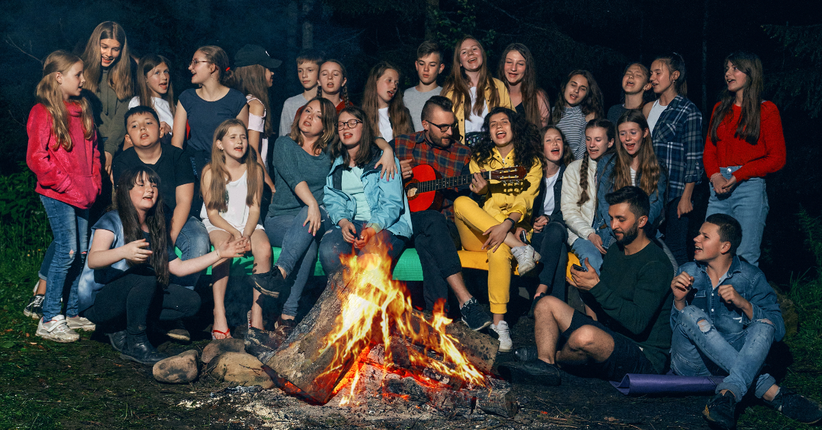 Singing to the children around the campfire