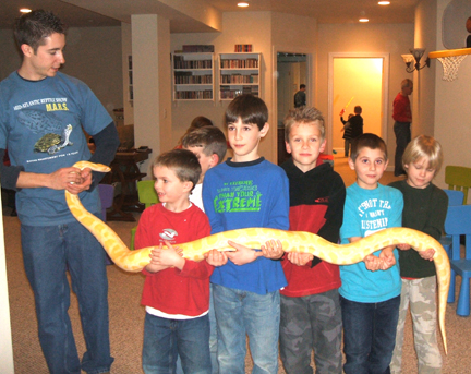 Presenter, Jeff, with an albino Burmese pythons and some kids.